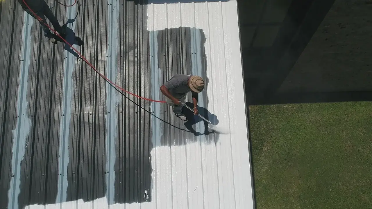 Roof maintenance worker cleaning gutters