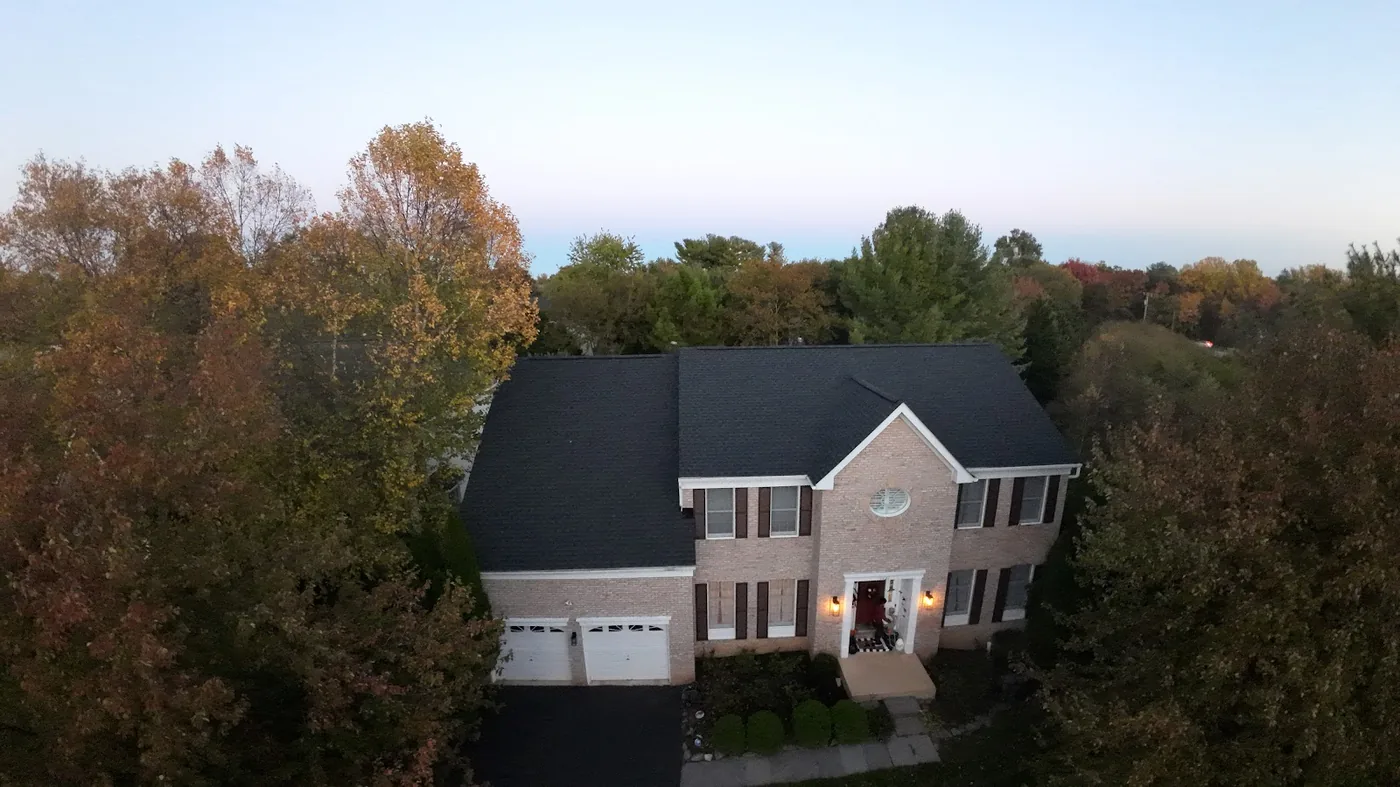 Dark architectural shingle roof on a brick colonial, seen from above